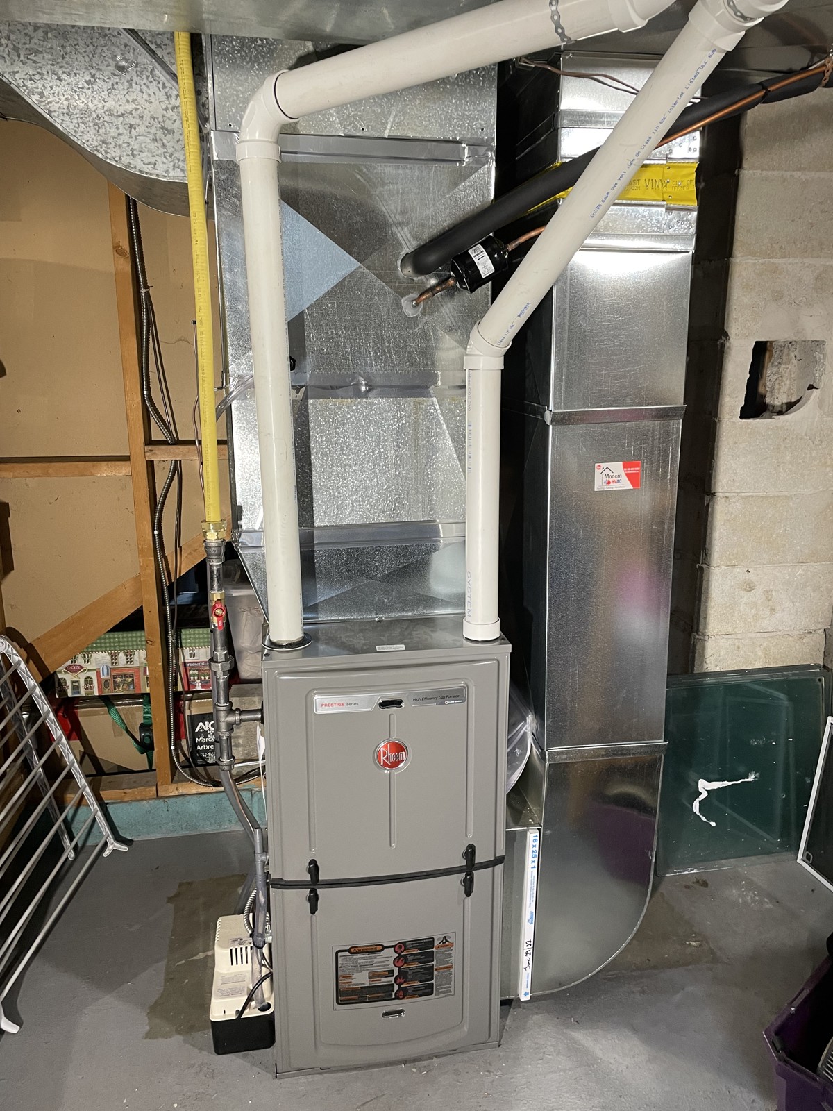 Rheem furnace installation with ductwork and vent pipes